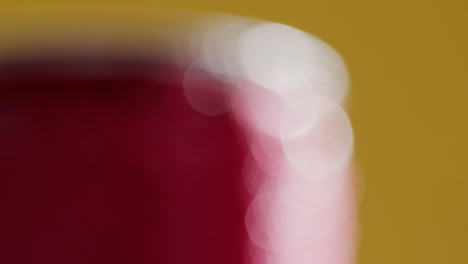 Defocused-Close-Up-Of-Condensation-Droplets-On-Takeaway-Can-Of-Cold-Beer-Or-Soft-Drink-Against-Yellow-Background